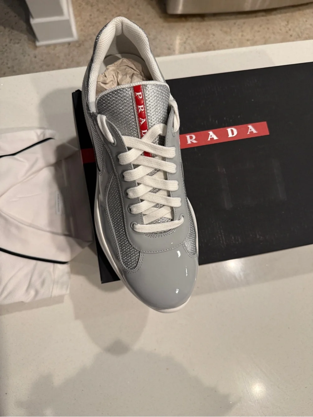 Prada Men’s Light Gray and White Lace-Up Sneakers with Red Logo Tape